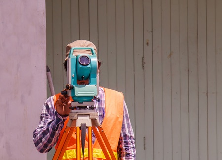 Man with land survey equipment