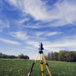 surveying camera set up over a field