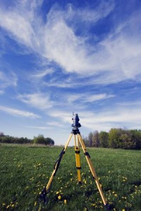 surveying camera set up over a field