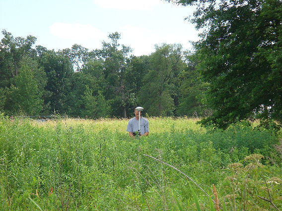 Man in using equipment for a land survey in Greenburg, IN