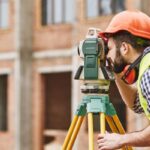 A land surveyor takes a picture while working