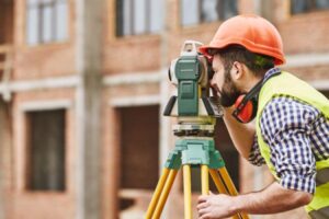 A land surveyor takes a picture while working